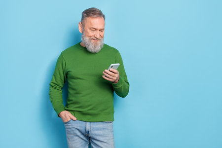 Photo of middle aged blogger read network news on device technology isolated blue color background