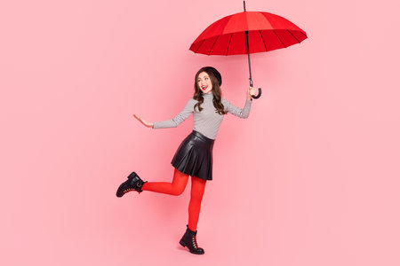 Photo of carefree stylish trendy lady catch fly air parasol enjoy sale discount copyspace isolated pastel color backgroundの写真素材