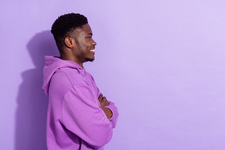 Profile side view portrait of attractive cheerful content guy folded arms copy space isolated over bright violet lilac color backgroundの写真素材