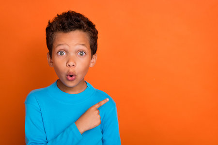 Photo of astonished boy arm direct empty space proposition big black friday sale wear stylish jumper...