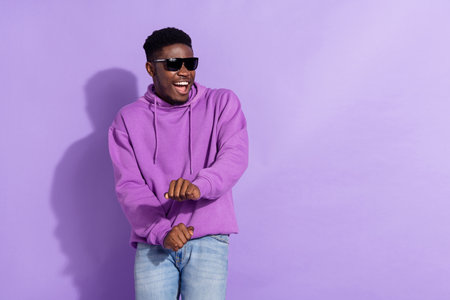 Portrait of excited cheerful man enjoy chilling entertainment free time isolated on violet color backgroundの写真素材