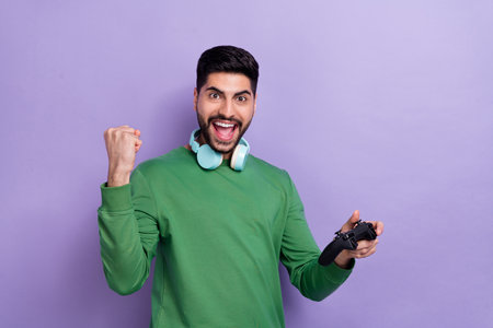 Photo of screaming optimistic cheerful gamer headphones shouting yeah yes win game on video game...