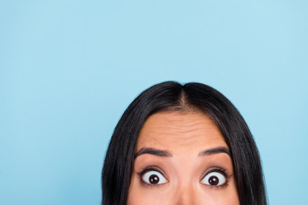 Close up cropped photo of nice cute gorgeous impressed woman with brunette hairstyle astonished looking isolated on blue color backgroundの写真素材