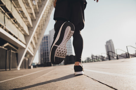 Cropped photo of leather sole quality sport footwear on running energetic man motivation concept urban town outdoorsの写真素材