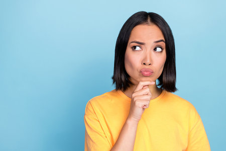 Portrait photo of young pretty adorable cute nice woman pouted lips look distrust empty space...