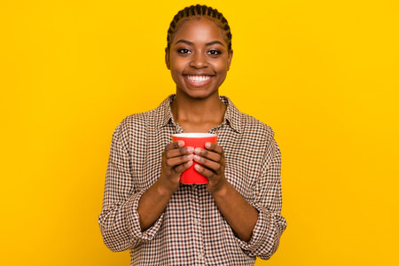 Photo of dreamy sweet woman wear plaid shirt drinking hot tasty beverage isolated yellow color...
