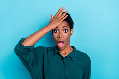 Portrait of attractive worried woman reaction forgot information lost isolated over bright blue color backgroundの写真素材