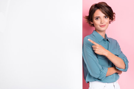 Photo of adorable stylish lady arm demonstrate white wall empty blank space cool proposition sale isolated on pink color backgroundの写真素材