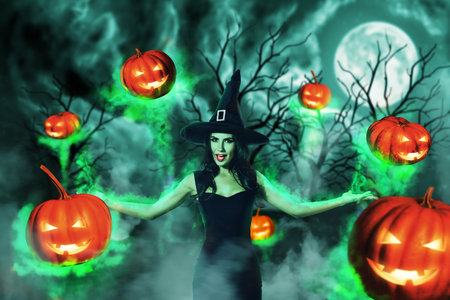 Composite collage image of terrifying mysterious witch girl satanic ritual flying carved pumpkins isolated on fear atmosphere forest backgroundの写真素材