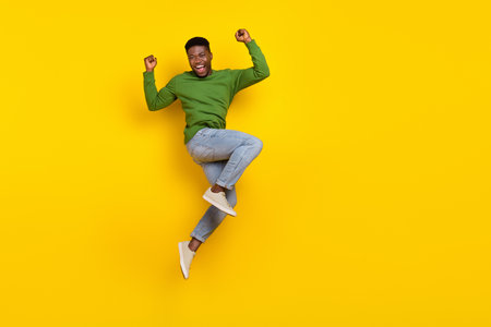 Full length body size view of attractive cheery guy jumping rejoicing attainment isolated over...