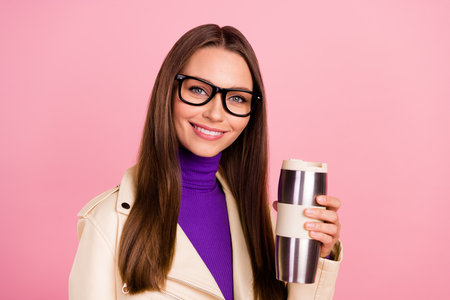 Photo of sweet millennial lady drink latte wear purple turtleneck jacket spectacles isolated on pink color backgroundの写真素材