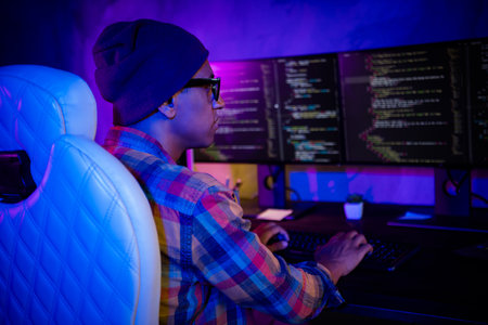 Profile photo of professional cybersecurity agent keyboard typing operating dark office room insideの写真素材