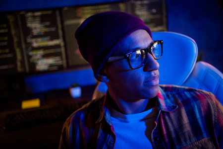 Portrait of intelligent web security expert sitting chair  workstation night insideの写真素材