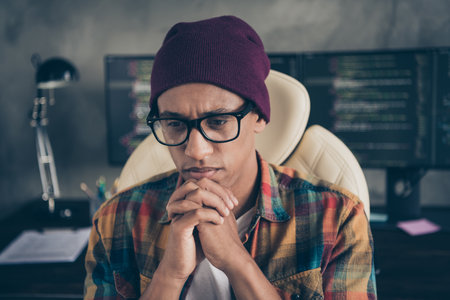 Photo of minded intelligent guy sitting chair hands touch chin brainstorming contemplate office indoorsの写真素材