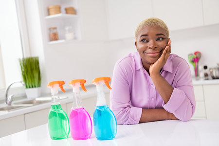 Photo of minded positive lady hand touch cheekbone brainstorming imagine cleaning house indoorsの写真素材