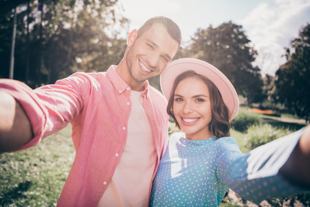 Photo of charming funny two people together wear casual outfits tacking selfie smiling outside gardenの写真素材