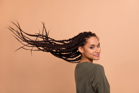Profile portrait of nice positive person flying hairdo look camera isolated on beige color...