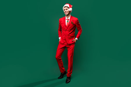 Full length body size view of attractive classy imposing confident cheerful guy posing isolated over green color backgroundの写真素材