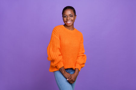 Photo of adorable satisfied young lady toothy smile look camera wear knit pullover isolated on violet color backgroundの写真素材