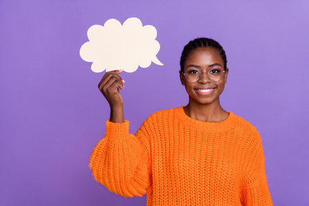 Portrait of pretty positive lady hand hold empty space paper cloud card isolated on violet color...