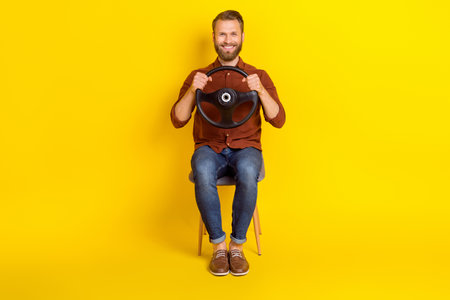 Full size photo of good mood positive man burgundy shirt hold steering wheel sit in new vehicle...