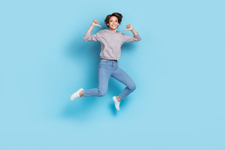 Full size photo of short hairdo millennial lady jump index herself wear shirt jeans boots isolated on blue color backgroundの写真素材