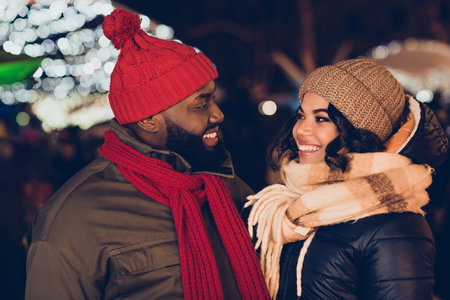 Photo of cute dreamy boyfriend girlfriend dressed winter season outfits enjoying x-mas miracle outdoors urban city streetの写真素材