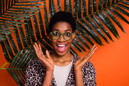 Portrait of attractive amazed cheerful trendy girl resting in tropics having fun isolated over...