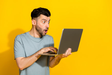 Photo of young crazy excited man typing laptop networking speechless unexpected freelancer worker...