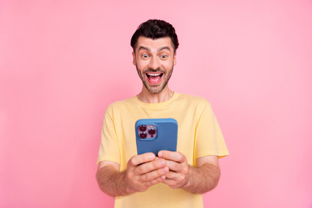 Photo of cheerful man blogger make instagram twitter video story streaming chatting followers subscribers isolated on pink color backgroundの写真素材