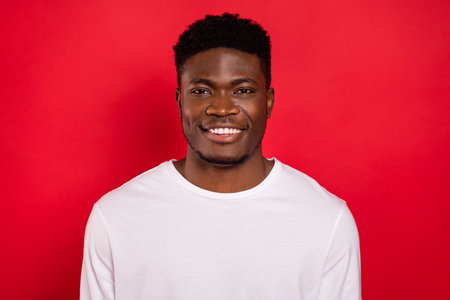 Photo of satisfied glad person toothy beaming smile look camera isolated on red color background