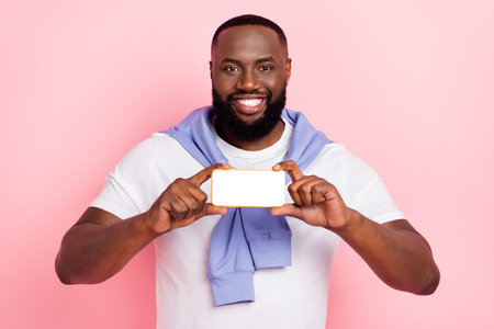 Photo of young handsome cheery man recommend show you new online service isolated on pink color backgroundの写真素材