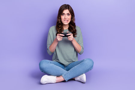 Photo of sad millennial lady bite lip intense game isolated on purple color background