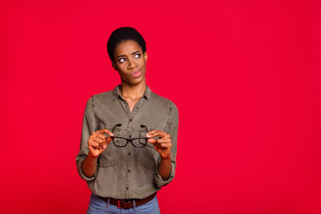 Photo of uncertain androgyne worker look empty space hesitate wear smart casual shirt isolated bright color backgroundの写真素材