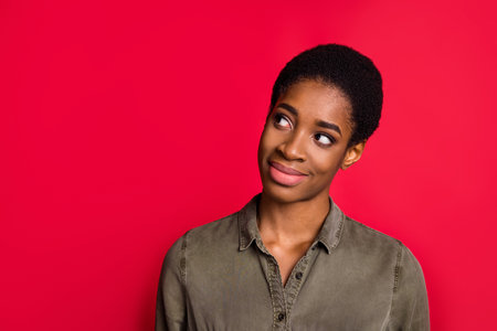 Portrait of attractive minded cheerful girl creating solution copy space isolated over vibrant red color backgroundの写真素材