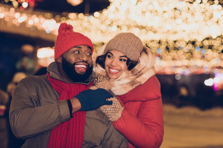 Photo of two peaceful idyllic partners hug touch hands enjoy evening lights atmosphere outdoorsの写真素材