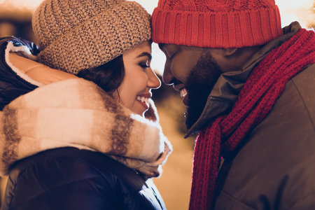 Photo of dreamy pretty boyfriend girlfriend dressed winter season outfits embracing enjoying x-mas moments outdoors urban city streetの写真素材
