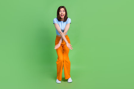 Full length photo of overjoyed pretty person enjoy dancing spend pastime isolated on green color backgroundの写真素材