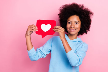 Photo portrait of cute pupil girl hold social media love heart icon smile dressed stylish blue...