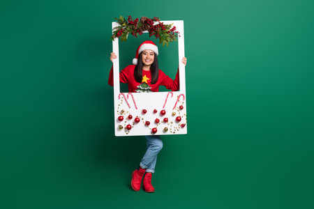Full length photo of sweet cute lady wear red ugly print xmas sweater holding decorations white...