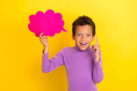 Photo of creative inspired small boy hold paper cloud card point finger brilliant isolated on yellow...
