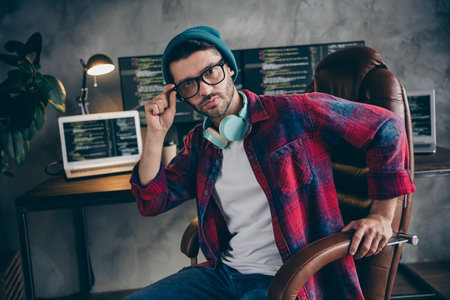 Photo of serious confident programmer wear earphones writing music sound producer gadget indoors workplace workshop homeの写真素材