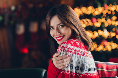 Profile portrait of adorable positive lady hand hug shoulder toothy smile decoration lights festive magic indoorsの写真素材