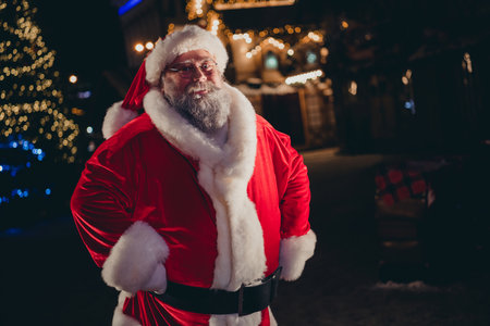 Photo of positive joyful funky retired old man santa claus wear red coat stand own house home...