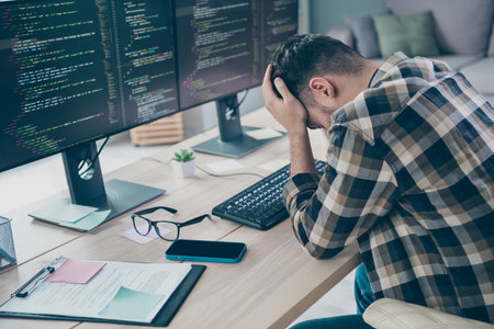 Photo of unhappy upset guy wear glasses founding app bugs modern device indoors workstation workshop homeの写真素材