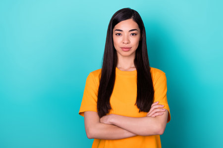 Photo of hr brunette long hairdo lady crossed arms wear yellow t-shirt isolated on teal color backgroundの写真素材