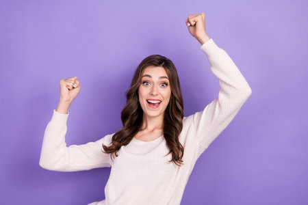 Photo of funky excited woman brunette hairstyle raise hands celebrate finally weekend holidays after work isolated on pastel violet color backgroundの写真素材