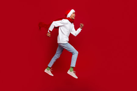 Full size profile portrait of energetic overjoyed guy run jump look empty space isolated on red...