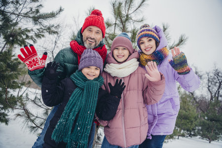 Photo of friendly cute husband wife small kids wear windbreakers waving arms hi you together outside...
