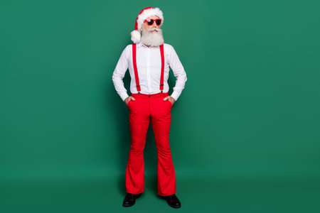 Full length photo of cool funky retired man dressed xmas costume dark eyewear empty space isolated green color backgroundの写真素材